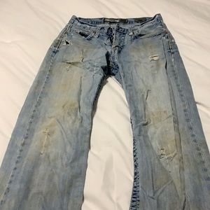 Worn out men’s buckle jeans